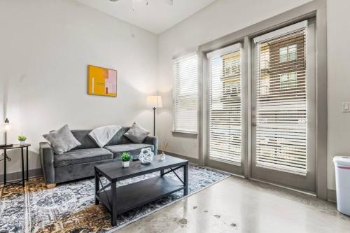 a living room with a couch and a table at Cozy Haven Steps Away from University Life in Fort Worth