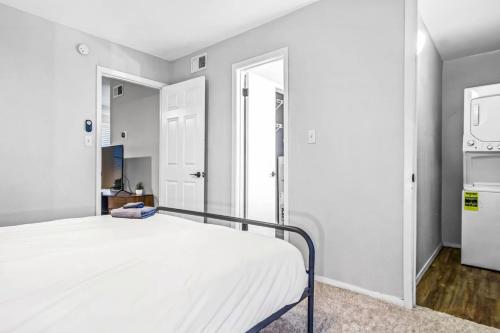 a bedroom with a bed and a mirror at Embrace Austins Vibrant Heart Elegant 1BR Haven in Austin