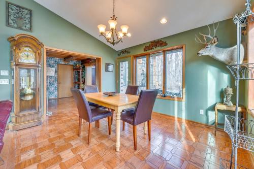 a dining room with a wooden table and chairs at Walk to Saylorville Lake Spacious Home with Deck! in Johnston