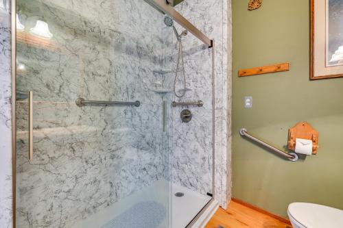 a bathroom with a shower with a glass door at Walk to Saylorville Lake Spacious Home with Deck! in Johnston