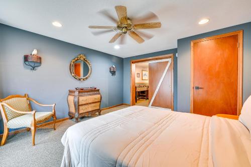 a bedroom with a bed and a ceiling fan at Walk to Saylorville Lake Spacious Home with Deck! in Johnston