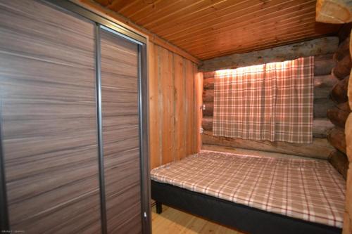 a small room with a bed in a cabin at Northern Lights in Levi