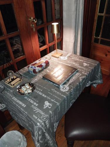 a table with a table cloth with a lamp on it at De La Grace in Potchefstroom