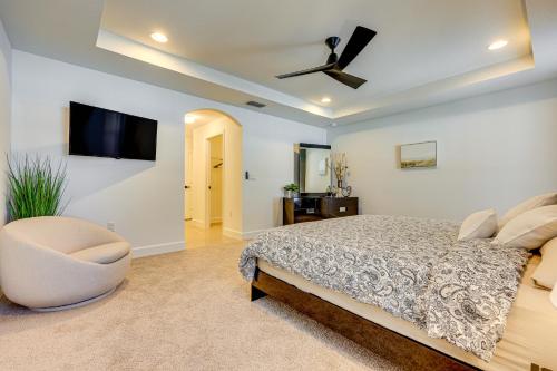 a bedroom with a bed and a ceiling fan at 8 Mi to Flagler Beach Home with Outdoor Dining! in Palm Coast