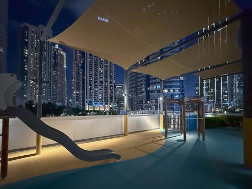 a balcony with a view of a city at night at The View of a Lifetime - Luxury Living with Full Burj Khalifa & Fountain Show - 1702 in Dubai