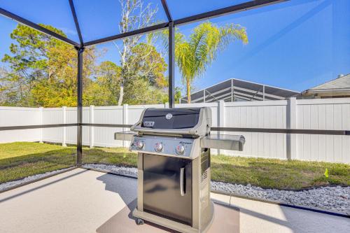 a kitchen with a grill in a backyard at 8 Mi to Flagler Beach Home with Outdoor Dining! in Palm Coast