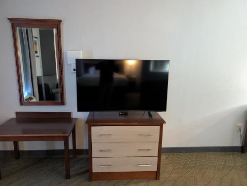 a flat screen tv sitting on top of a dresser at Wingate by Wyndham Chesapeake in Chesapeake