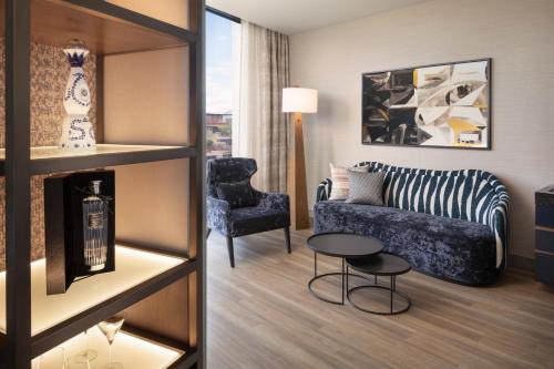 a living room with a couch and a chair at Caesars Republic Scottsdale, a Hilton Hotel in Scottsdale