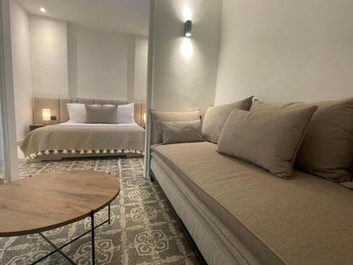 a living room with a couch and a bed at Dar Kbira - Sidi Bou Said in Sidi Bou Saïd