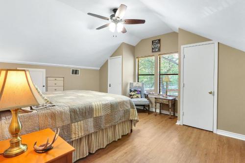 a bedroom with a bed and a ceiling fan at Happy Hideaway in Wimberley