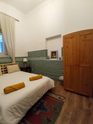 a bedroom with a large bed with yellow pillows on it at Montijo Garden - Alojamento Rural in Montijo