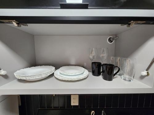 a kitchen counter with plates and utensils on it at Flat Quartz 503 in Cabedelo