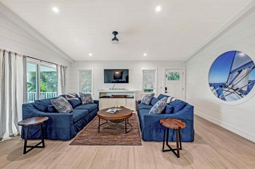 a living room with two blue couches and a table at Totally Beachin' in Bradenton Beach