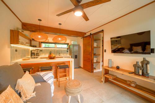 a living room with a couch and a kitchen at Wabi Sabi Hana in Punta Uva