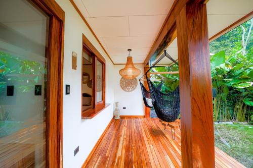 an open door to a house with a porch at Wabi Sabi Hana in Punta Uva