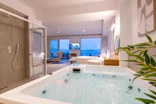 A bed or beds in a room at Achillion Luxury Corfu Villa & Suites