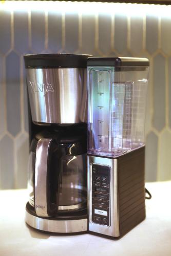 a coffee maker sitting on top of a microwave at Wabi Sabi Hana in Punta Uva