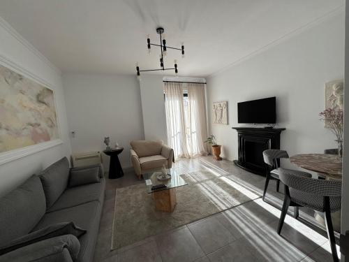 a living room with a couch and a table at Denny's Apartment City Center in Tirana
