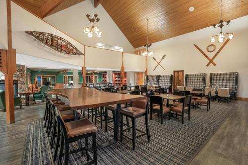 a dining room with wooden tables and chairs at Holiday Inn Express & Suites Hayward by IHG in Hayward