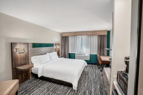 a hotel room with a bed and a television at Holiday Inn Express & Suites Hayward by IHG in Hayward