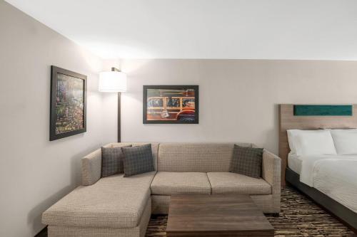 a living room with a couch and a bed at Holiday Inn Express & Suites Hayward by IHG in Hayward