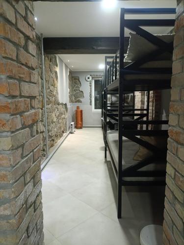 a room with a brick wall and a shelf of wine bottles at 46 Loft apartment with king-size bed in Chernihiv