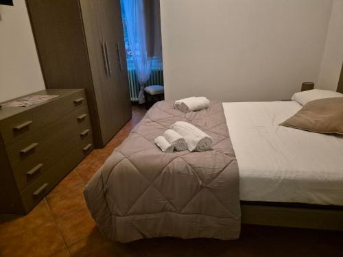a bedroom with two beds and a dresser at Locanda Rocchetta-Premilcuore in Premilcuore