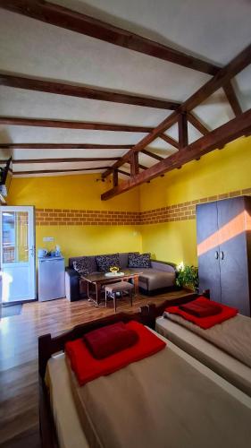 a living room with two beds and a couch at Стаи за гости Върбите in Sapareva Banya