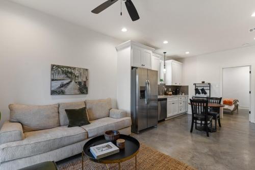 a living room with a couch and a kitchen at Bourbon House King Bed Luxury Amenities Fast WiFi in Lafayette