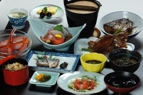 a table with plates of food and bowls of food at Mihokan in Mihonosekichō