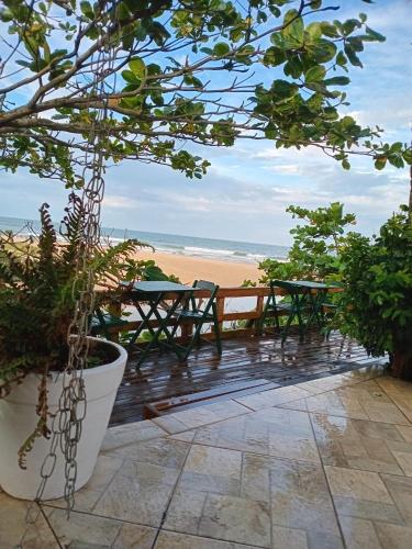 a patio with a view of the beach at Vila Penelope Guest House in Balneário Camboriú