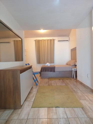 a bedroom with a bed and a desk in a room at Vila Penelope Guest House in Balneário Camboriú