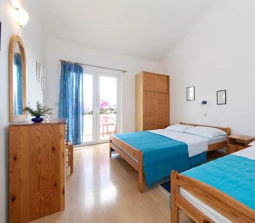 a bedroom with two beds and a large window at Apartment Blue in Igrane