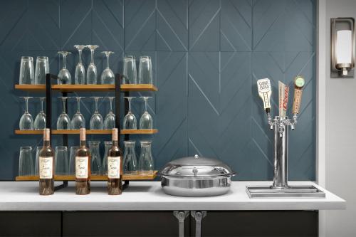a counter with bottles of wine and a pot on it at Staybridge Suites Raleigh-Durham Airport-Morrisville by IHG in Morrisville