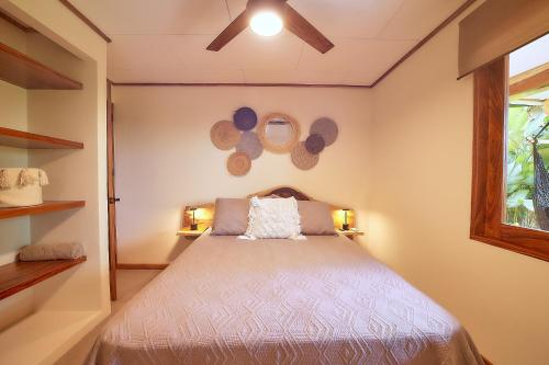 a bedroom with a bed and a window at Wabi Sabi Sora in Punta Uva