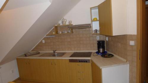 a small kitchen with a sink and a staircase at Apartment Na Rozcestí in Lipno nad Vltavou