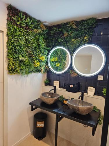 two sinks in a bathroom with two mirrors at Appartement SPA - W&M Suite in Clermont-lʼHérault