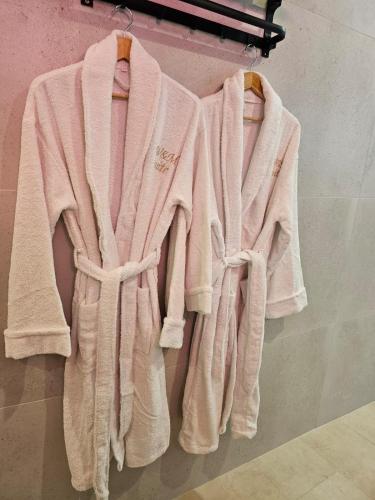 a group of towels hanging on a rack at Appartement SPA - W&M Suite in Clermont-lʼHérault