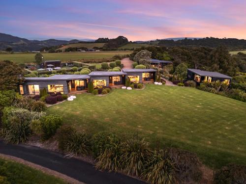 an aerial view of a house with a lawn at Villas Waiheke in Onetangi