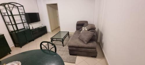 a living room with a couch and a table at Wonderful 1 Bed Room Apartment in Luanda