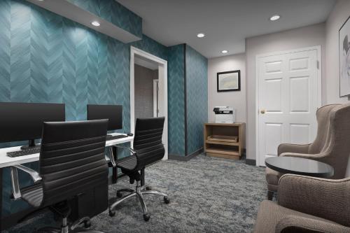 an office with chairs and a desk with a computer at Staybridge Suites Raleigh-Durham Airport-Morrisville by IHG in Morrisville