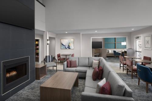 a living room with a couch and a fireplace at Staybridge Suites Raleigh-Durham Airport-Morrisville by IHG in Morrisville