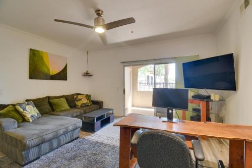 a living room with a couch and a tv at Red Rox Phoenix Condo with Patio about 3 Mi to Airport in Phoenix