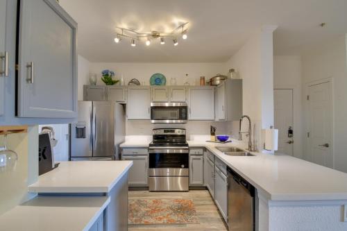 a kitchen with white cabinets and stainless steel appliances at Red Rox Phoenix Condo with Patio about 3 Mi to Airport in Phoenix