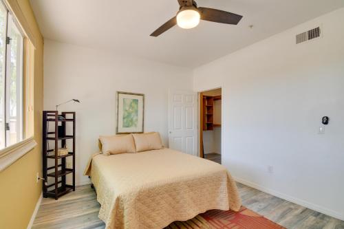 a bedroom with a bed and a ceiling fan at Red Rox Phoenix Condo with Patio about 3 Mi to Airport in Phoenix