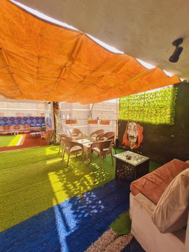 a room with a table and chairs under a tent at Castle Hotel in Cairo