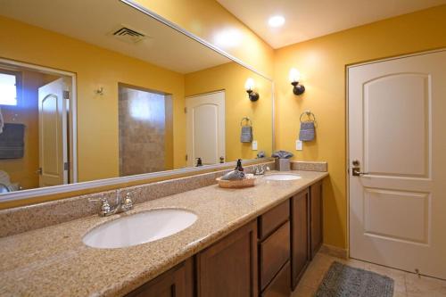 a bathroom with two sinks and a large mirror at Incredible Beach View 3Bed Condo in La Paz