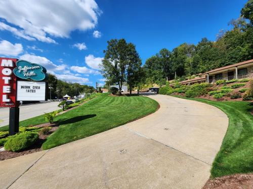 a walkway in front of a building with a sign at Jefferson Hills Motel in Clairton