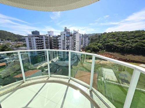 a glass balcony with a view of a city at APT 804 - Brava Beach - 3 Quartos - 2 Vagas Garagem in Cabeçudas