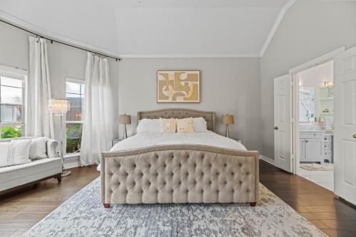 a bedroom with a large bed with a tufted headboard at Urban Oasis in Plano 5BD & Heated Pool in Plano
